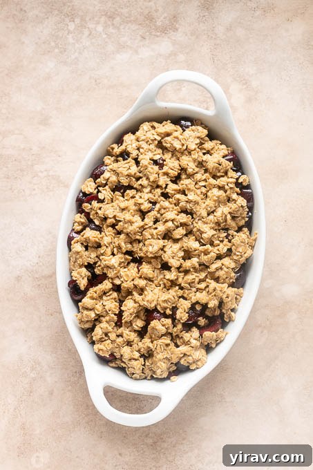 Unbaked cherry crisp with oat crumble topping.
