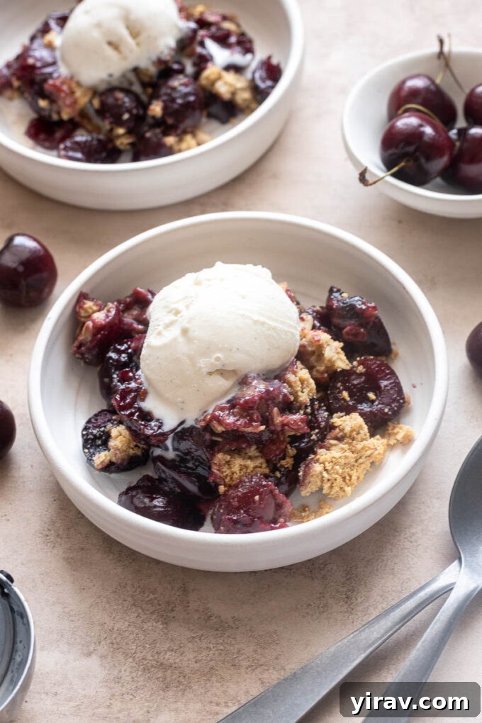 Easy fresh cherry crisp served warm with vanilla ice cream.