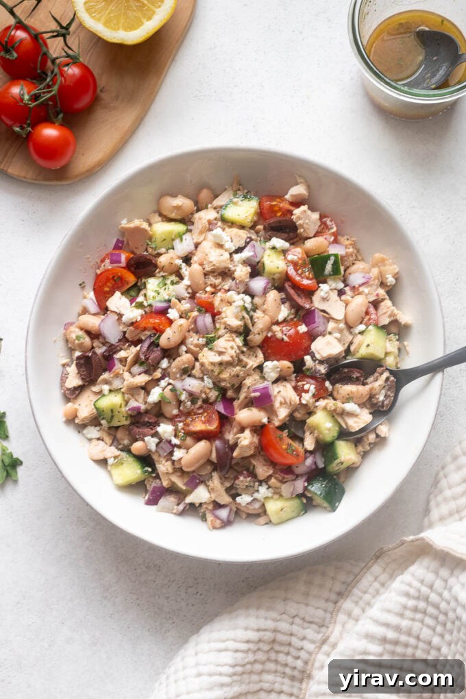 Mediterranean Tuna and White Bean Salad with Lemon Dressing 3 Overhead view of Mediterranean tuna white bean salad served in a white bowl.
