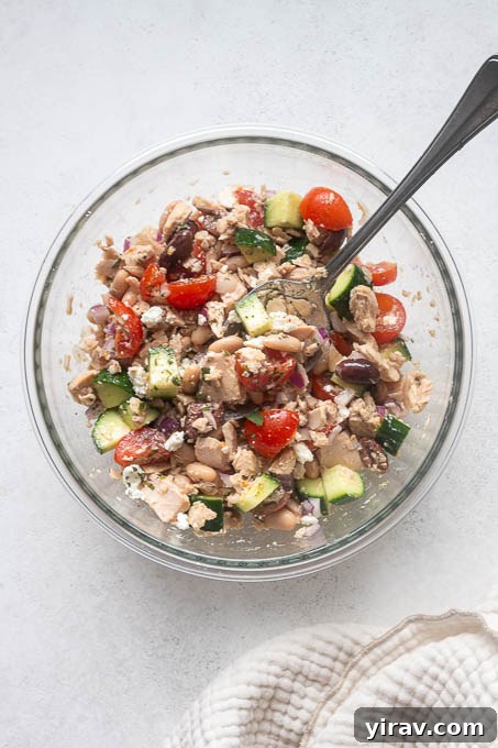 Mediterranean Tuna and White Bean Salad with Lemon Dressing 6 Dressed tuna white bean salad tossed in a mixing bowl.