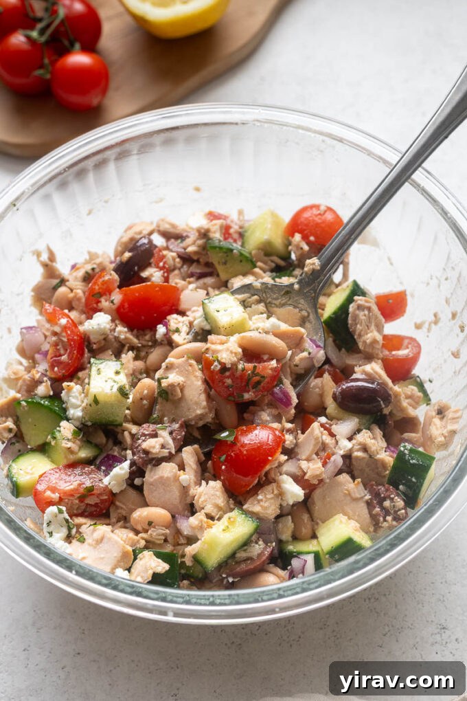 Mediterranean Tuna and White Bean Salad with Lemon Dressing 7 Tuna white bean salad tossed together in a glass mixing bowl.