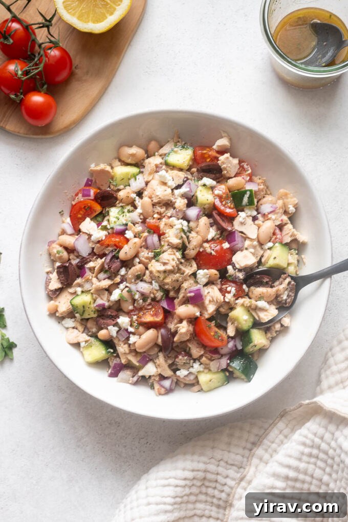 Mediterranean Tuna and White Bean Salad with Lemon Dressing 8 Cannellini bean tuna salad in a white bowl with serving spoon.