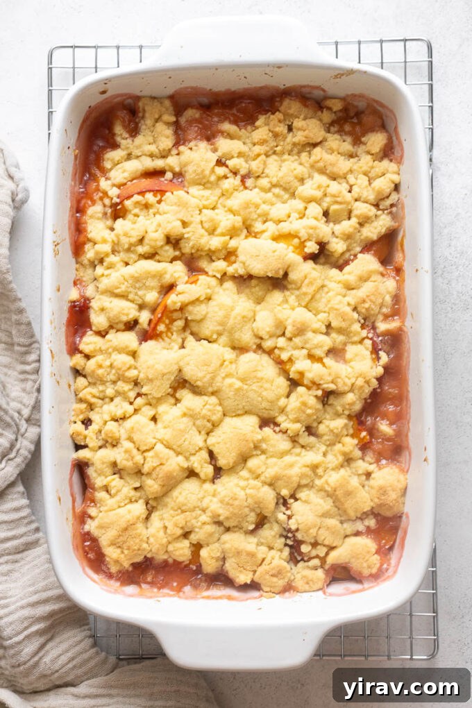 Fresh Peach Cobbler Recipe with Golden Biscuit Topping 9 Peach cobbler with fresh peaches cooling on wire rack.