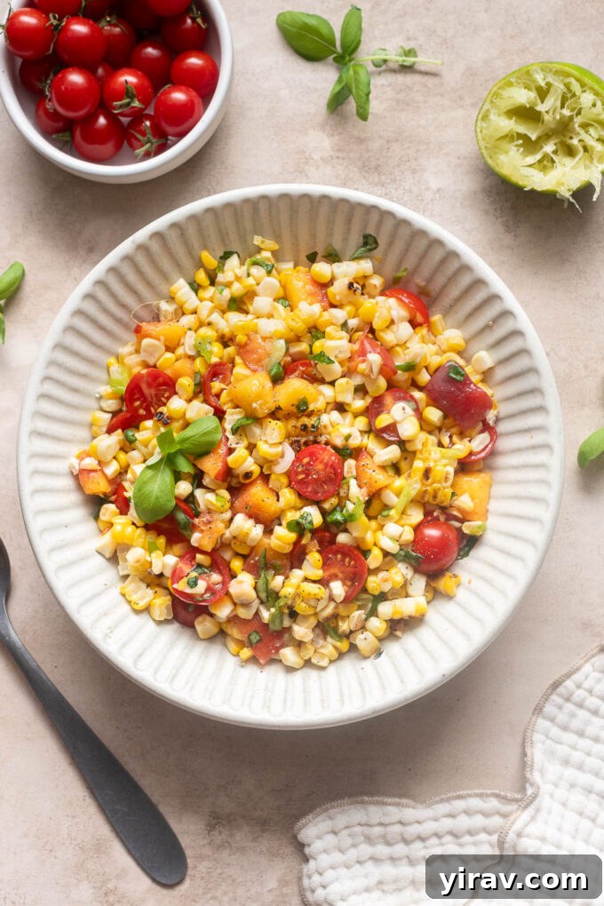 Summer Peach, Tomato and Corn Salad with Basil 3 Overhead view of grilled corn salad with peaches, cherry tomatoes, green onions and fresh basil.