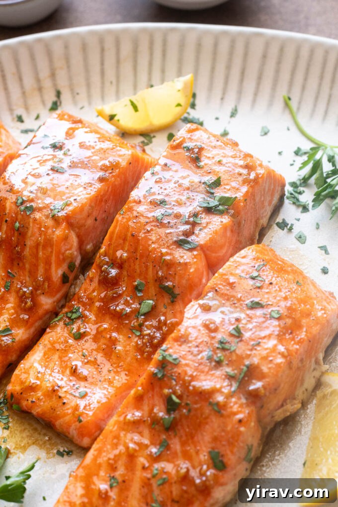 Honey Garlic Glazed Salmon Recipe 9 Honey garlic salmon on a platter with parsley and lemon.