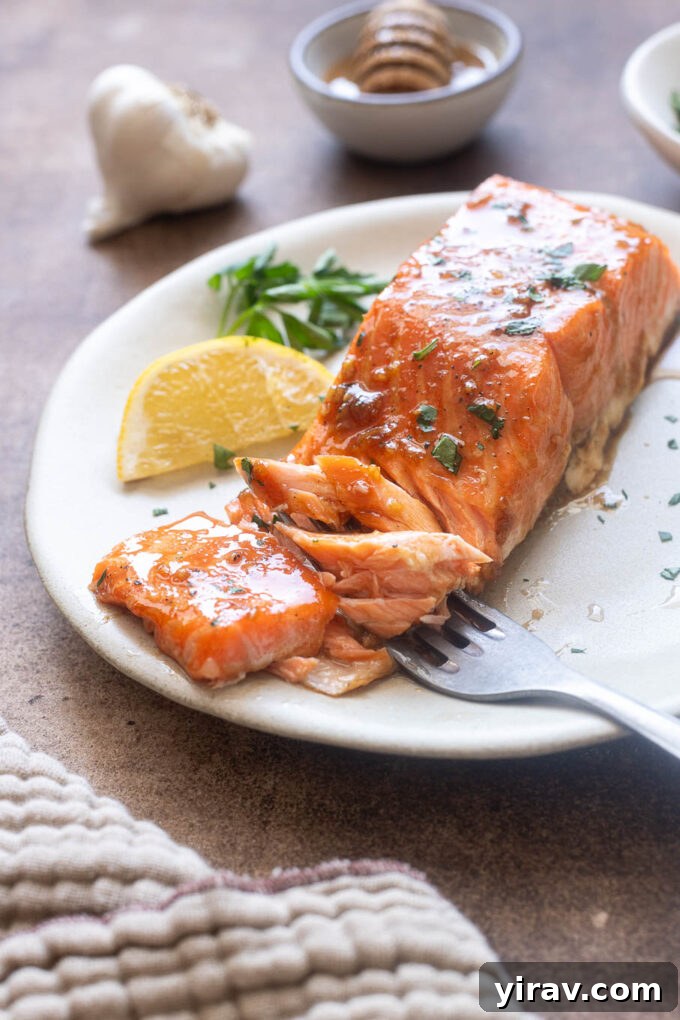 Honey Garlic Glazed Salmon Recipe 9 Forkful of honey garlic salmon on a plate.