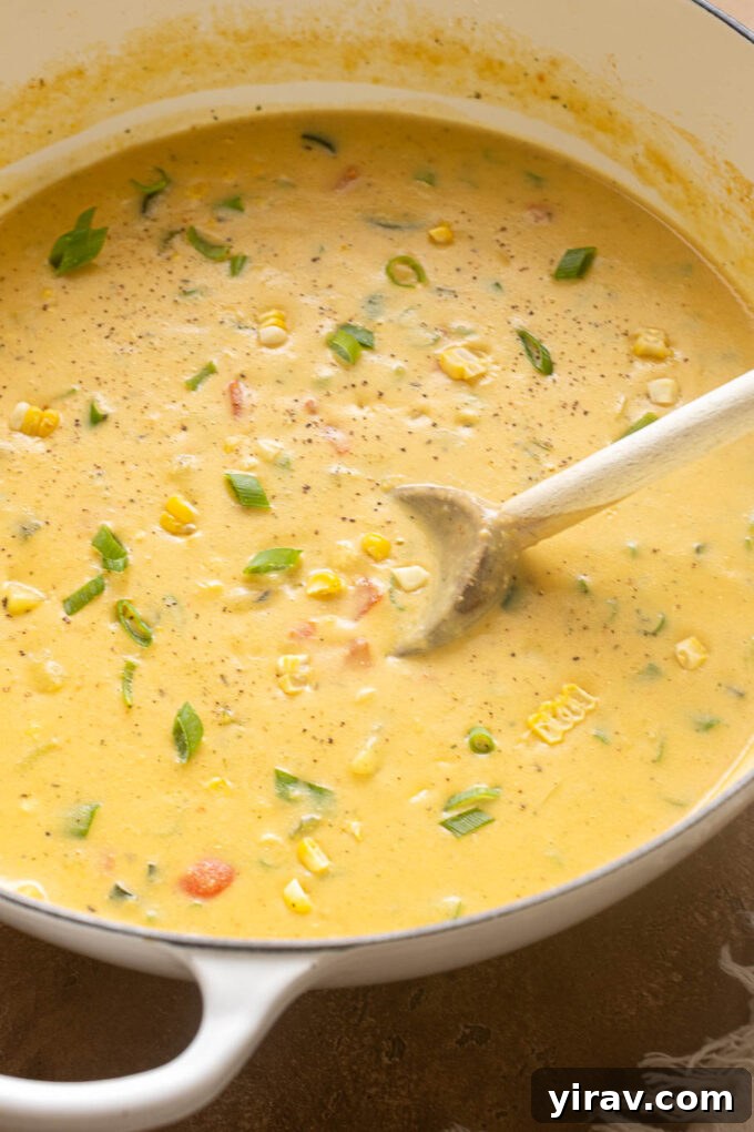 Creamy Zucchini and Corn Chowder with Crispy Bacon 5 Creamy zucchini and corn chowder with potatoes, bacon and green onions in a white Dutch oven.